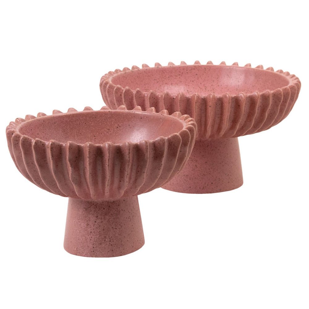 Two pink speckled ceramic pedestal bowls with fluted edges on a white background.