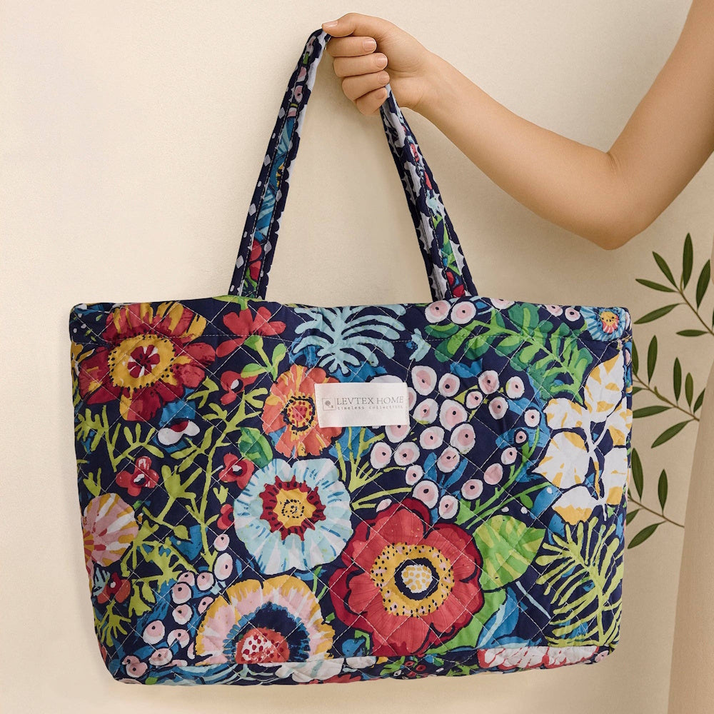 Levtex Home quilted tote bag with a vibrant navy floral pattern and colorful garden print. Large quilted fabric handbag.