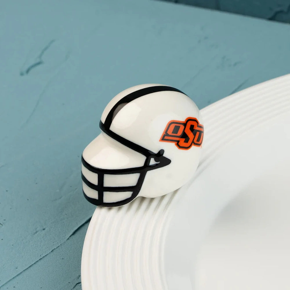 Ceramic Oklahoma State University football helmet figurine attached to the rim of a white platter.