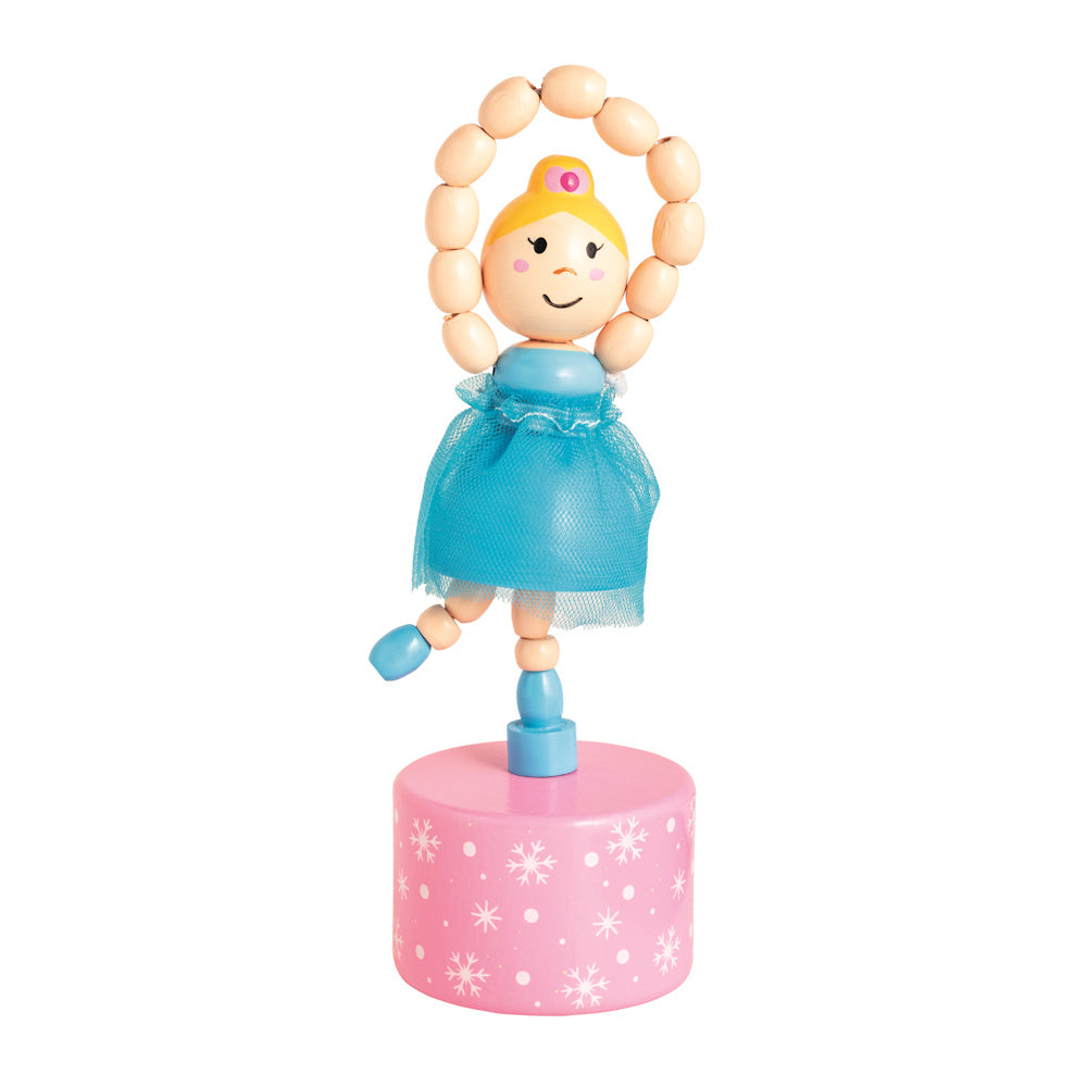 Wooden ballerina push-up toy in a blue tulle tutu on a pink snowflake base, ideal for Nutcracker-themed holiday decor.
