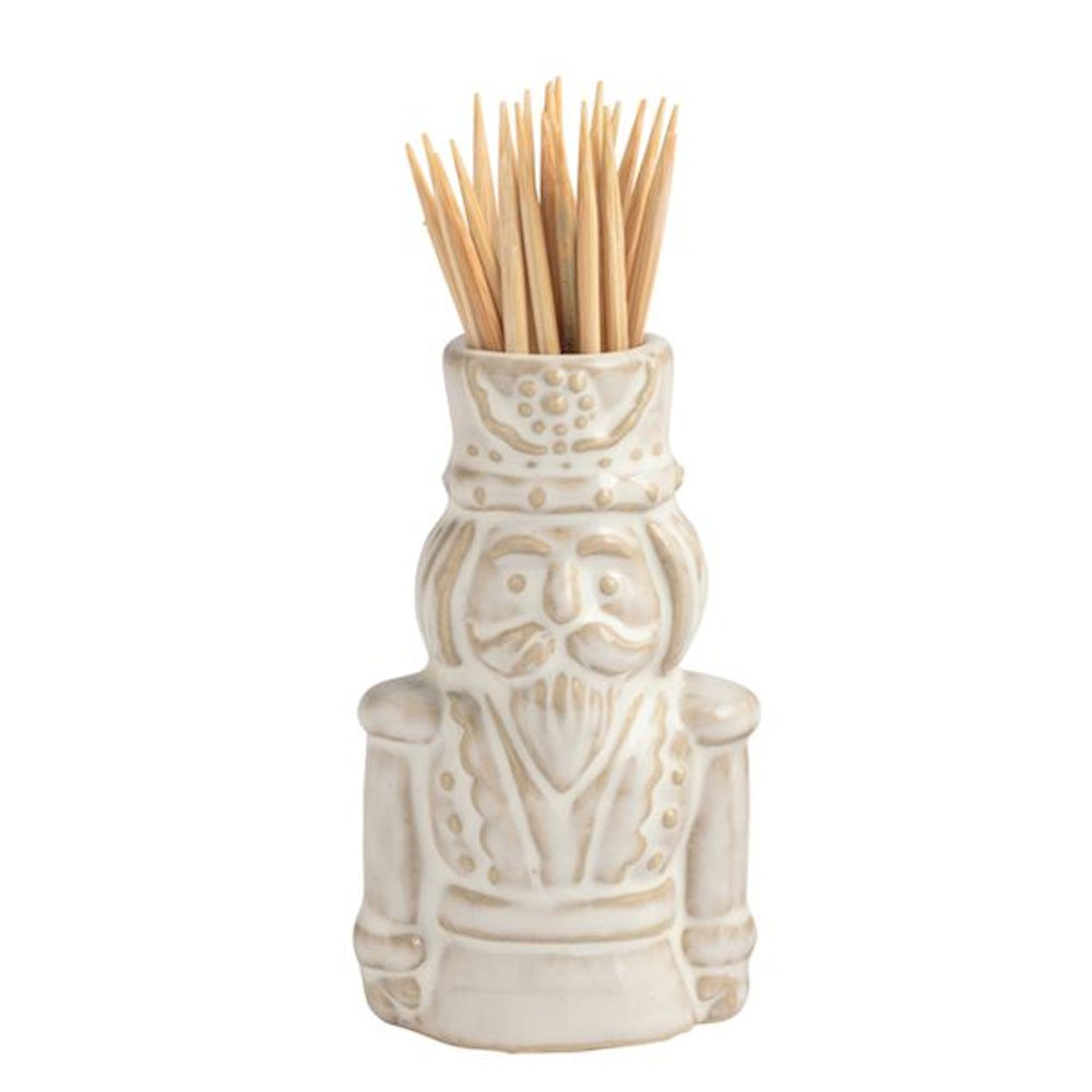 White ceramic nutcracker-shaped toothpick holder filled with wooden toothpicks.