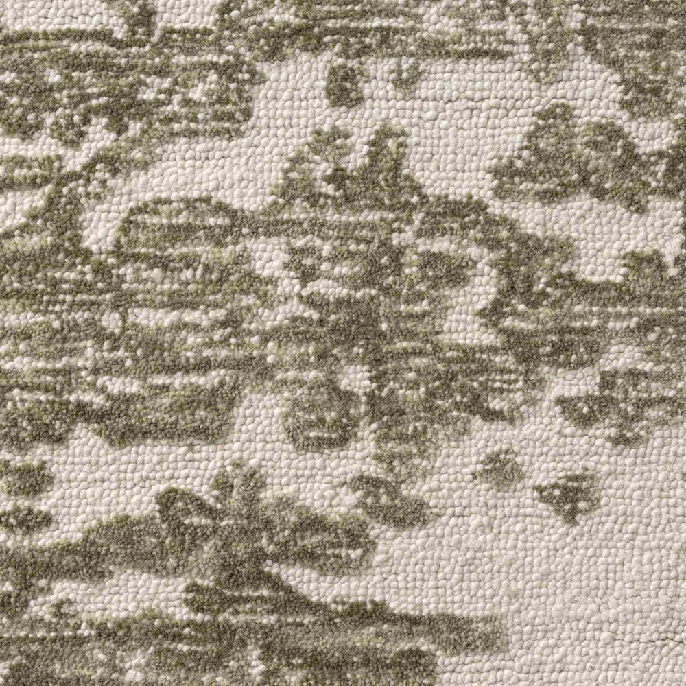 Close-up of a hand-tufted Nuvia rug featuring a textured loop pile in sage green and ivory ivory botanical patterns.