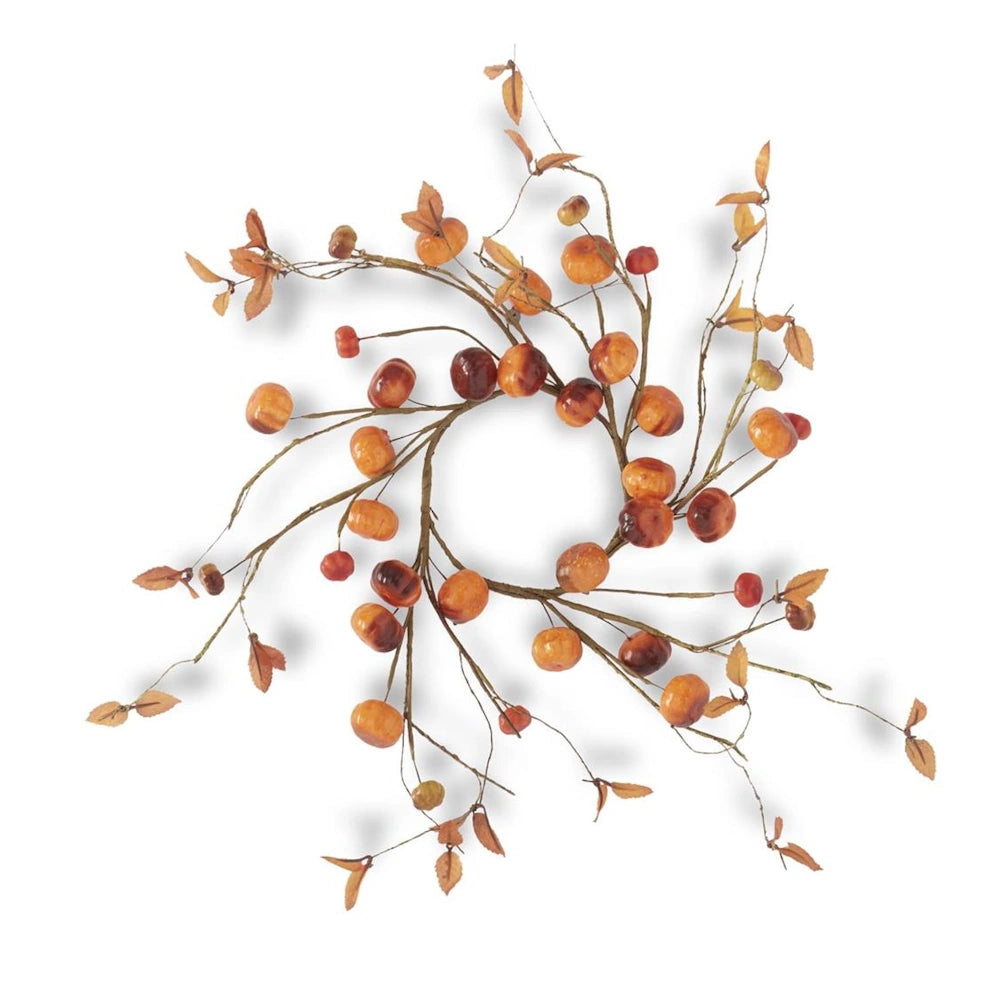 Autumn candle ring wreath featuring mini orange pumpkins, brown berries, and dried leaves on wire twigs.