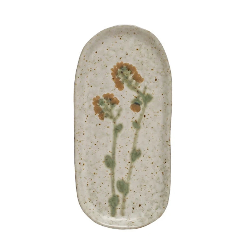 Elongated off-white speckled ceramic tray with an organic shape, decorated with painted orange flowers on stems.