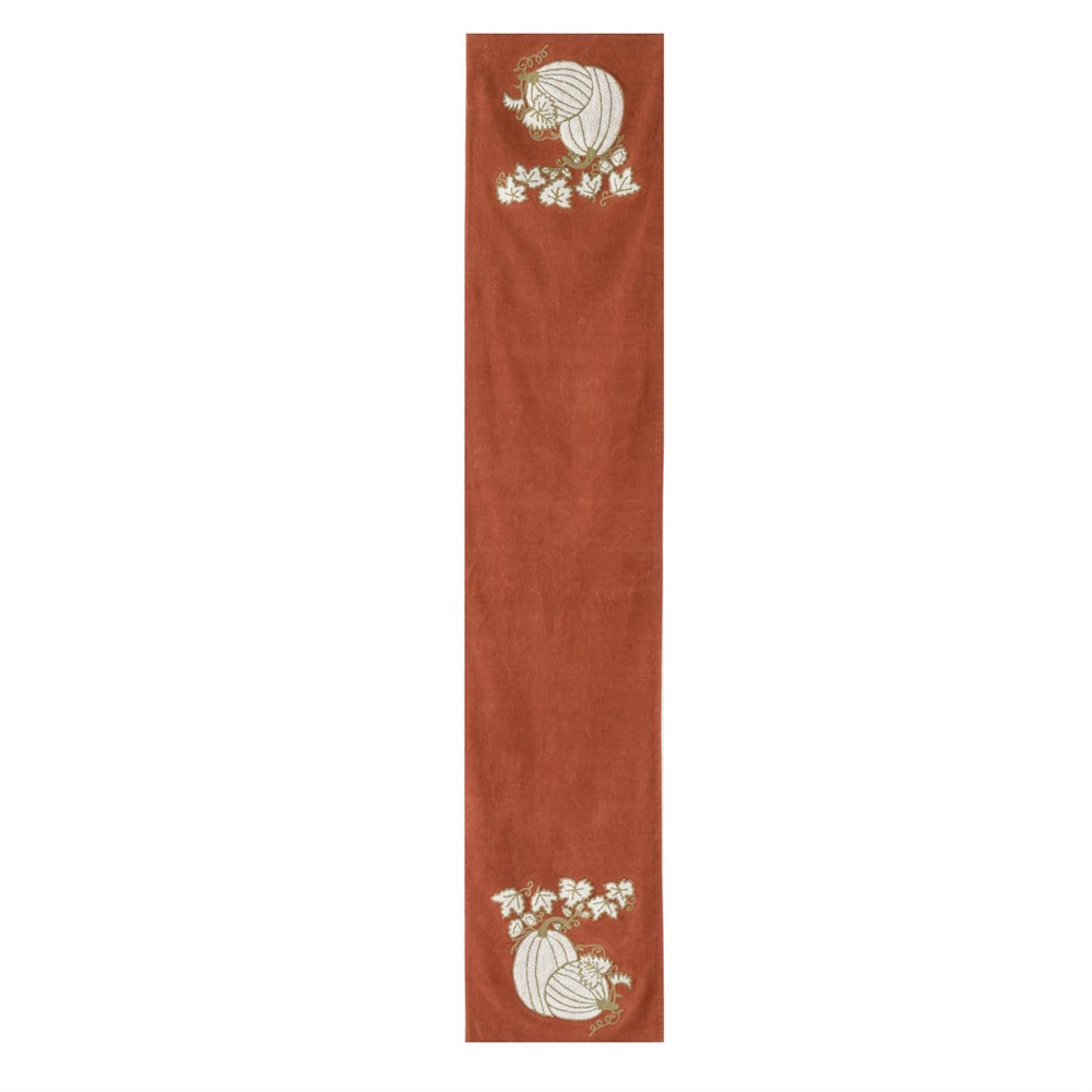 Orange velvet table runner with white embroidered pumpkins and vine leaves on both ends.