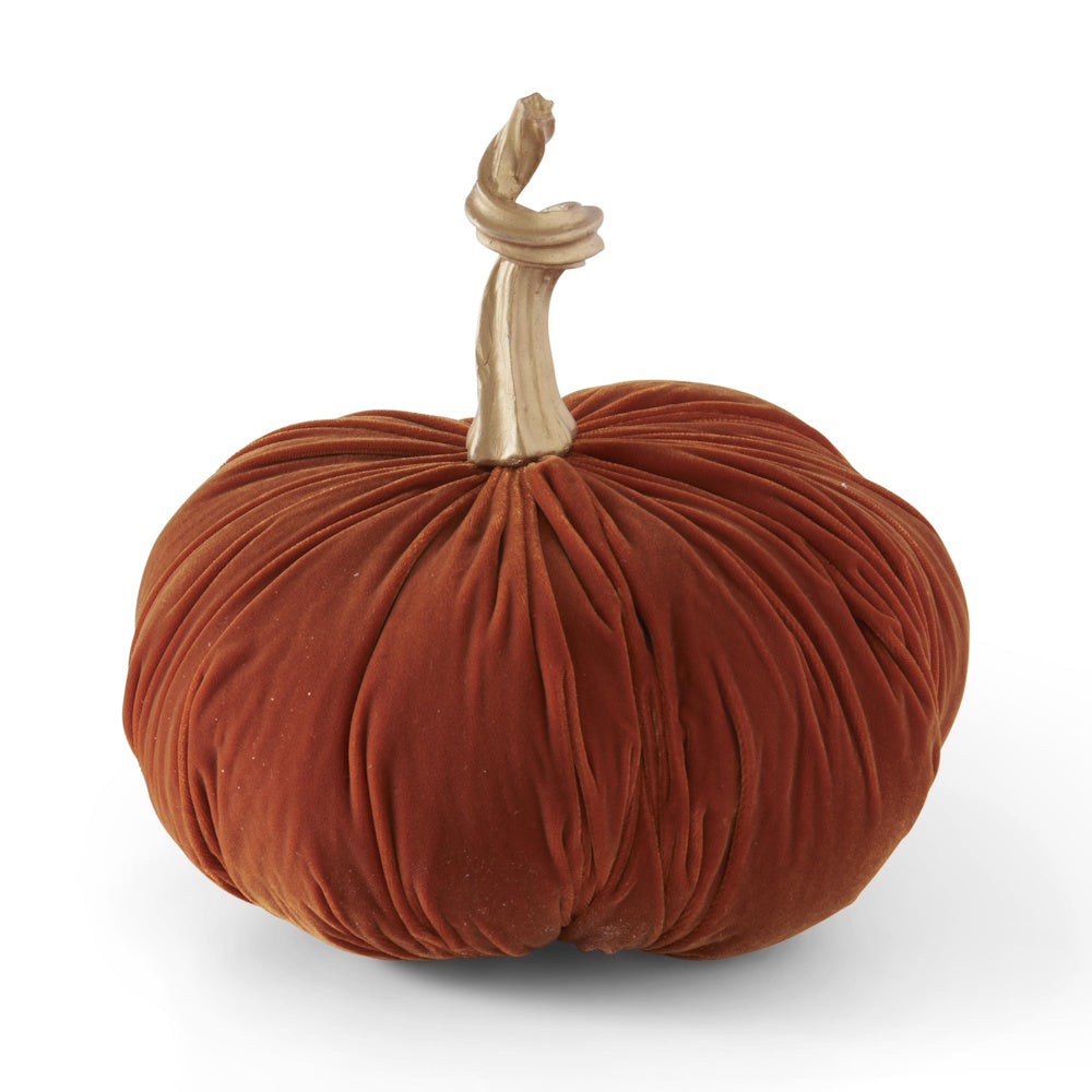 Plush rust-orange velvet decorative pumpkin with a metallic gold twisted stem on a white background.