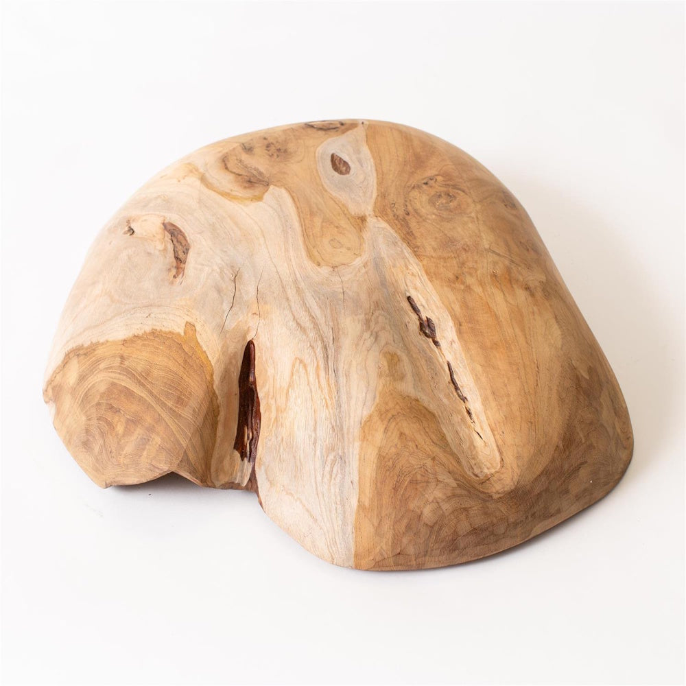 Handcrafted organic-shaped teak wood bowl with natural grain patterns and knots on a white background.