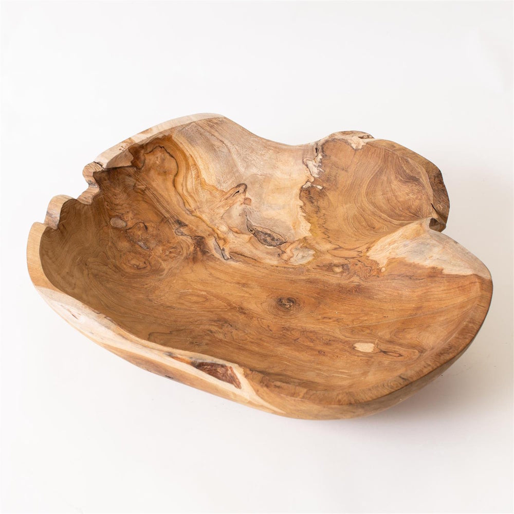 Hand-carved organic teak wood bowl with natural grain patterns and live edges on a white background.
