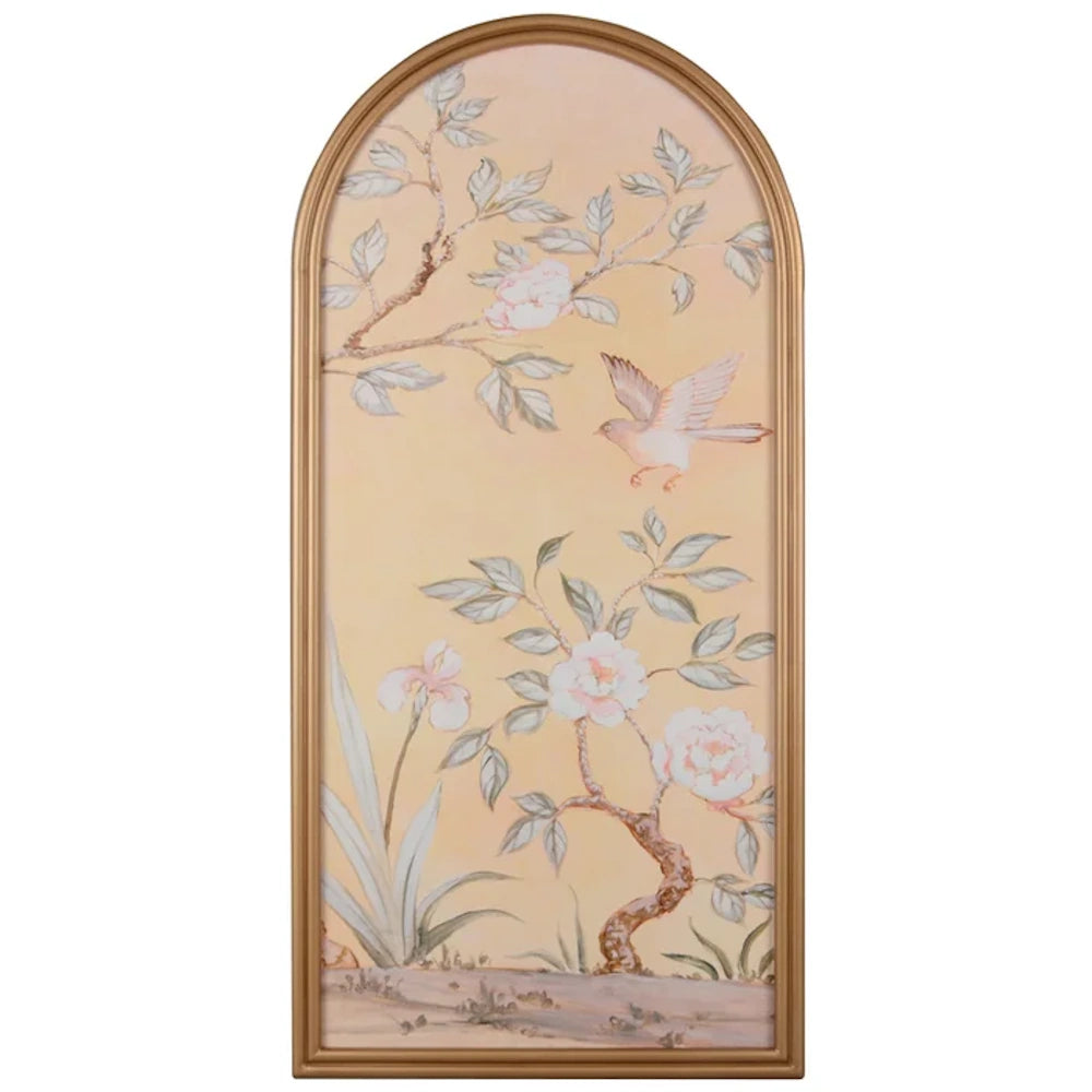 Arched gold framed wall art featuring a Chinoiserie style painting of pink flowers and a bird on a peach background.