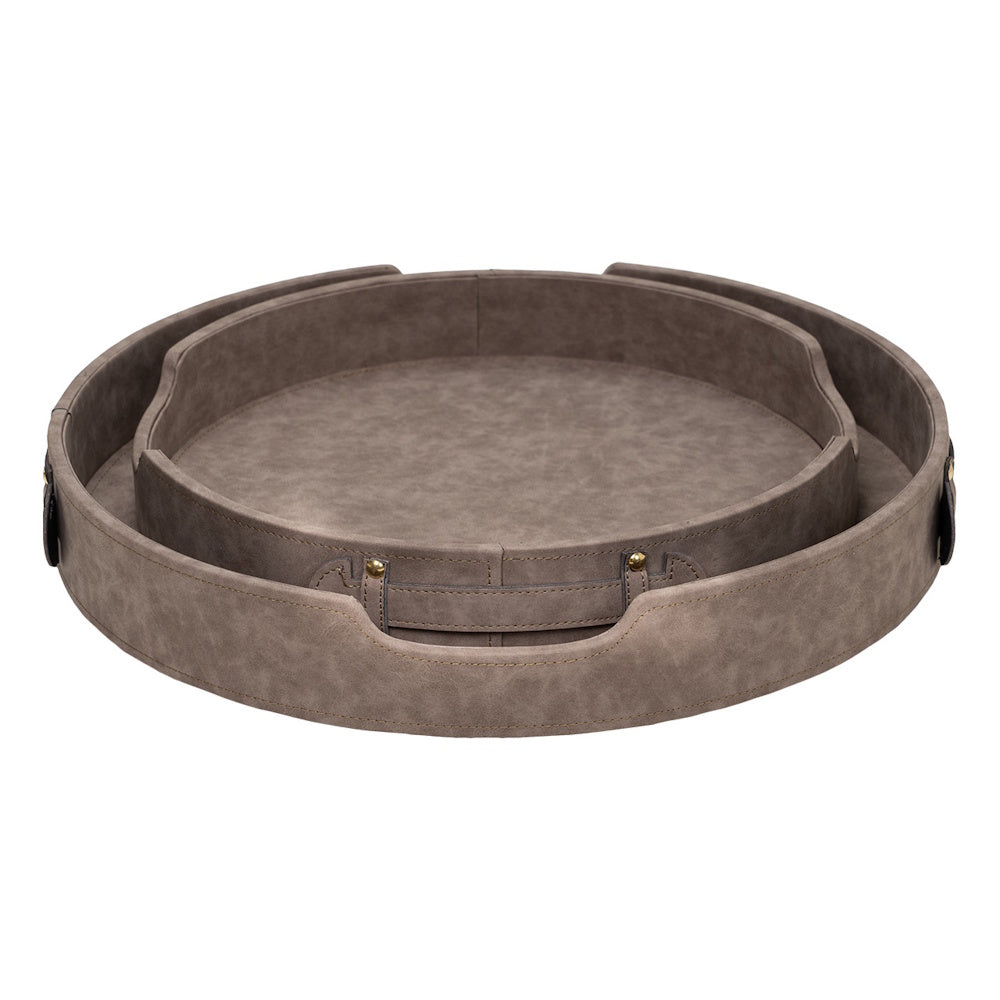 Two round grey faux-leather nesting trays with handles and gold stud accents on a white background.