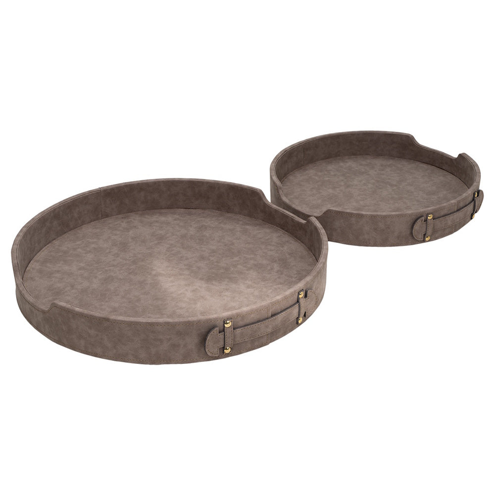 Two round brown faux-leather decorative trays with side handles and gold stud accents on a white background.