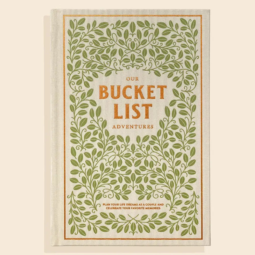 Our Bucket List Adventures guided journal for couples with a green leaf border and gold embroidered lettering.