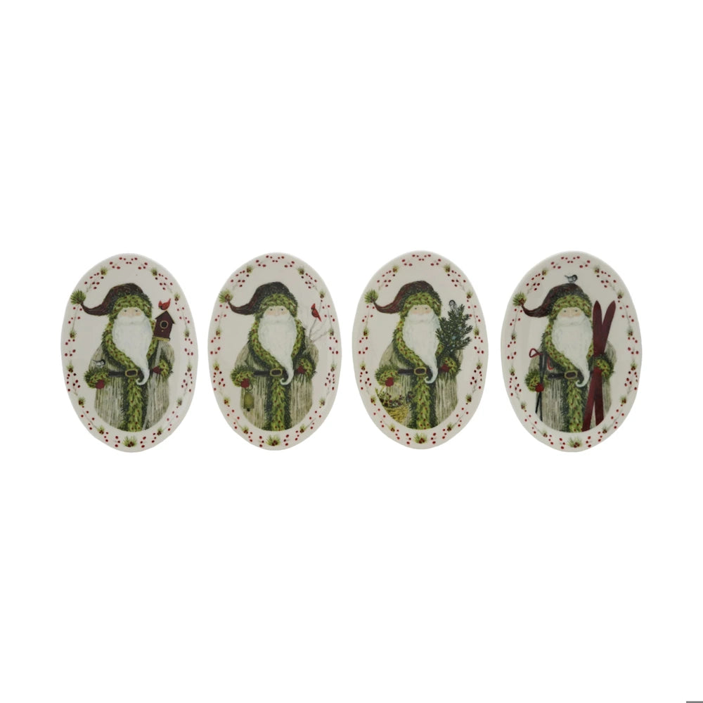 Set of four oval white platters, each featuring Santa in a distinct holiday design with winter motifs.