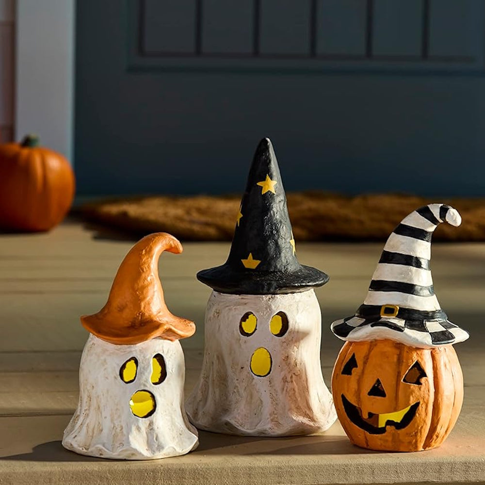 Three papier-mâché Halloween lanterns featuring two ghosts and a jack-o'-lantern wearing witch hats.