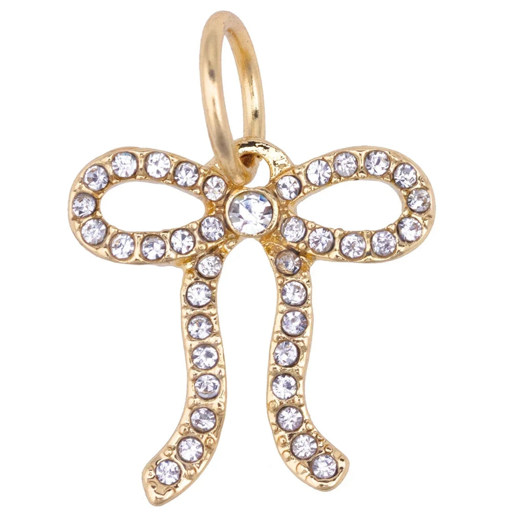 Gold pavé looped bow charm with sparkling crystals and a jump ring for jewelry making and necklaces.
