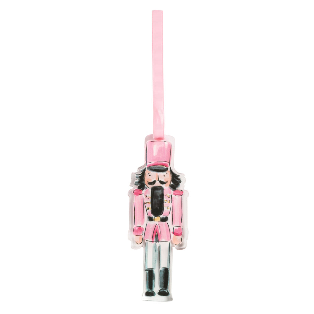 Pink acrylic nutcracker ornament with a hanging ribbon.