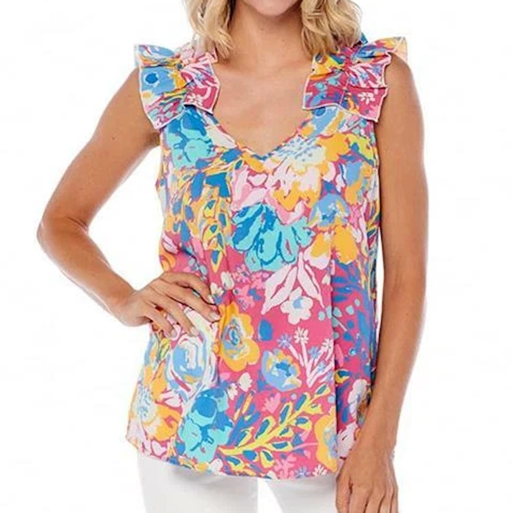 A woman wearing a vibrant, multicolored pink floral tank top with ruffle sleeves.