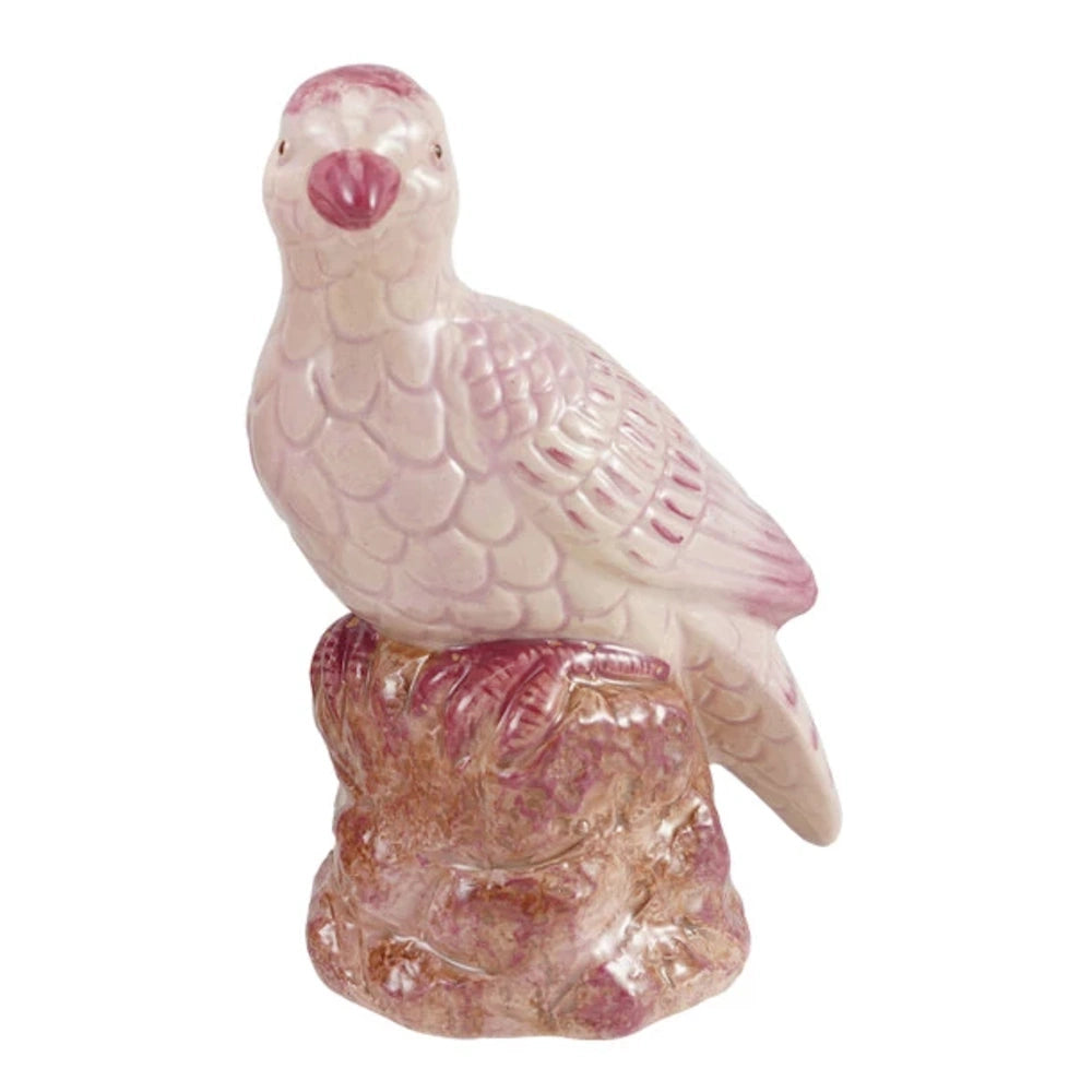 Hand-painted pink stoneware bird figurine perched on a textured base.