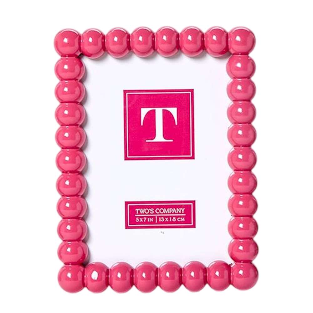 A glossy pink photo frame with a beaded hobnail border.