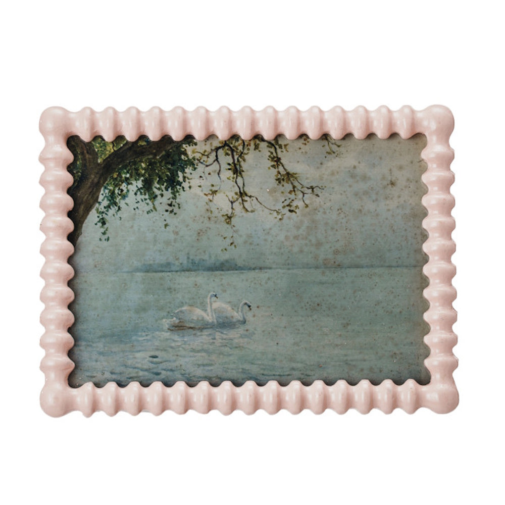 Textured pink picture frame holding a vintage reproduction art print of swans on water.