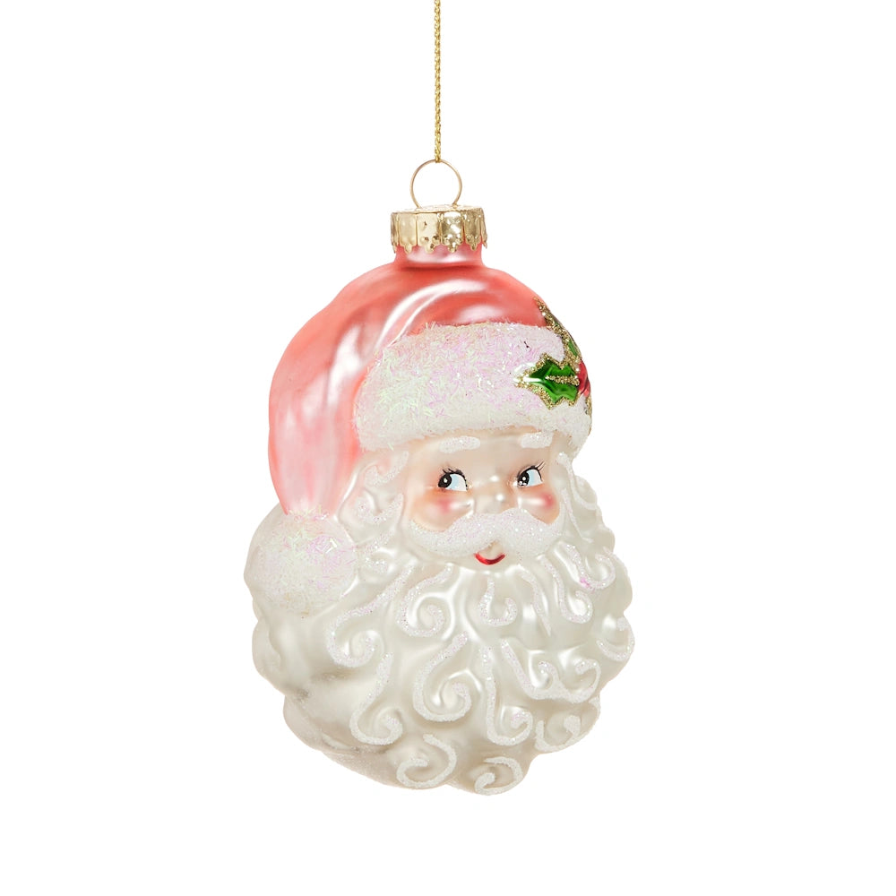 Glass Santa head Christmas tree ornament with a pink hat and white beard, hanging against a white background.
