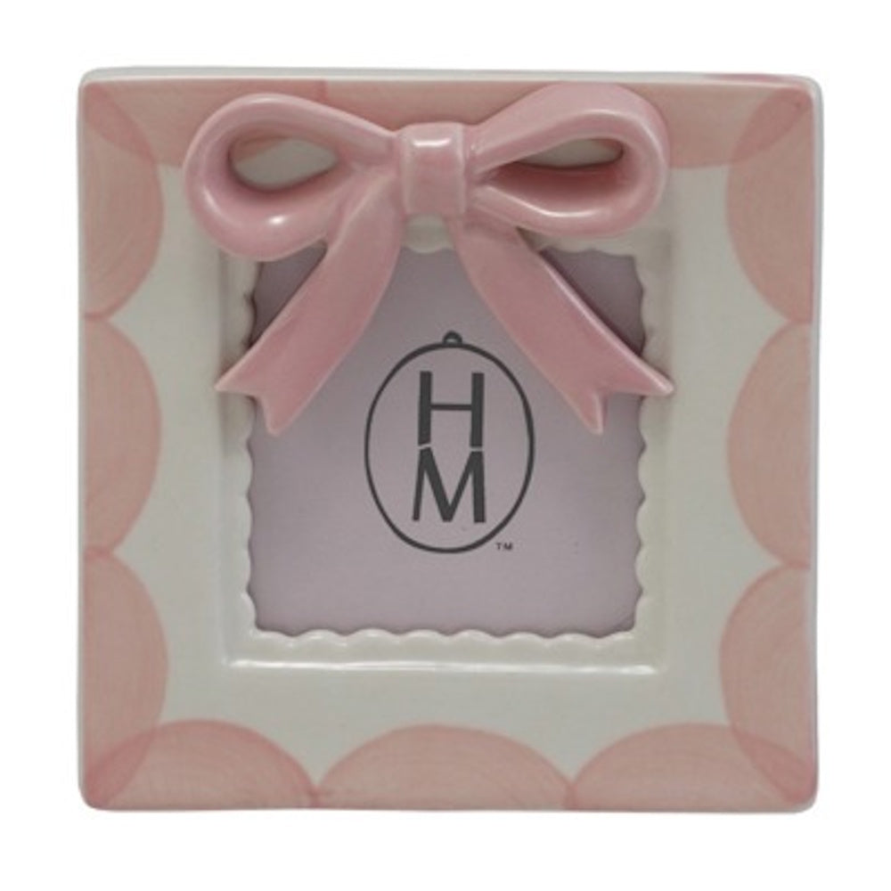 Square white stoneware photo frame with pink scalloped edges and a large 3D pink bow at the top.