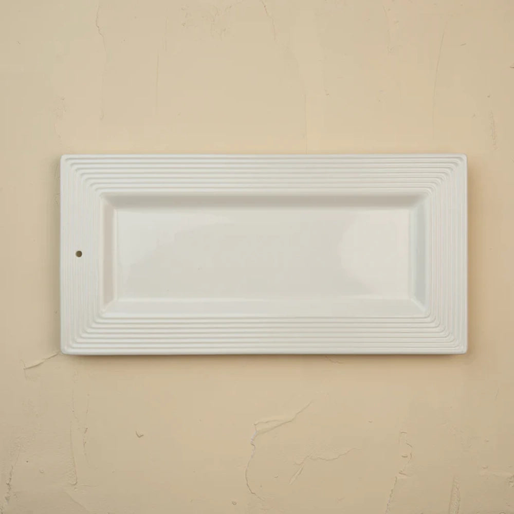 Rectangular white ceramic bread tray with a textured pinstripe rim and a small hole on the left side.