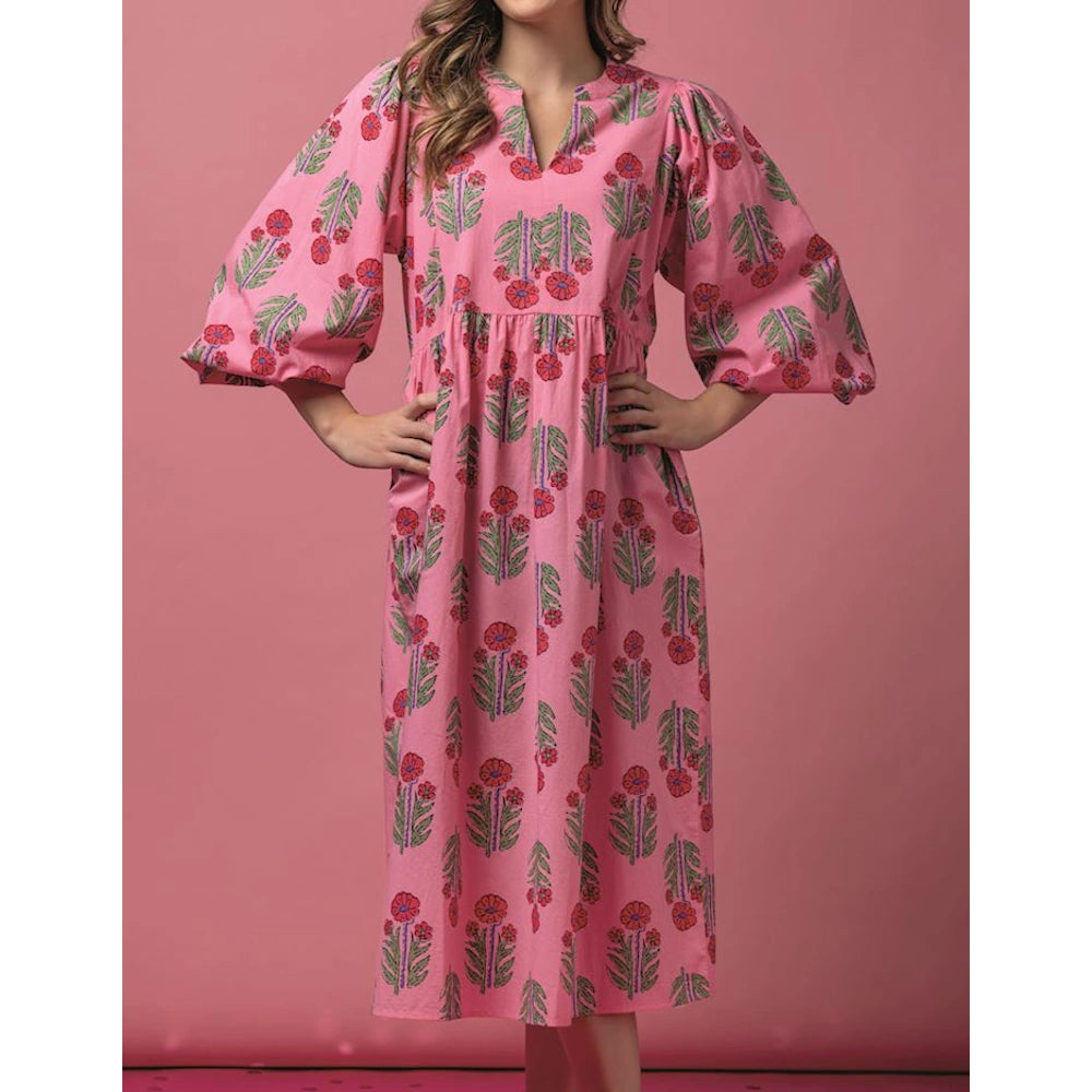 Pink midi dress with red and green floral print, featuring a V-neckline, voluminous balloon sleeves, and an empire waist.