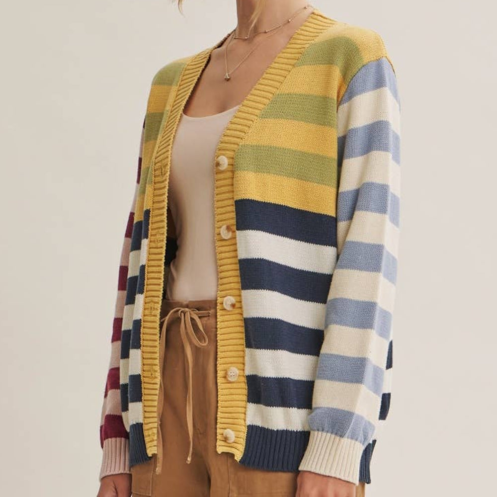 Colorful color-blocked striped cardigan with button-down front, yellow trim, and blue, cream, and pink panels.