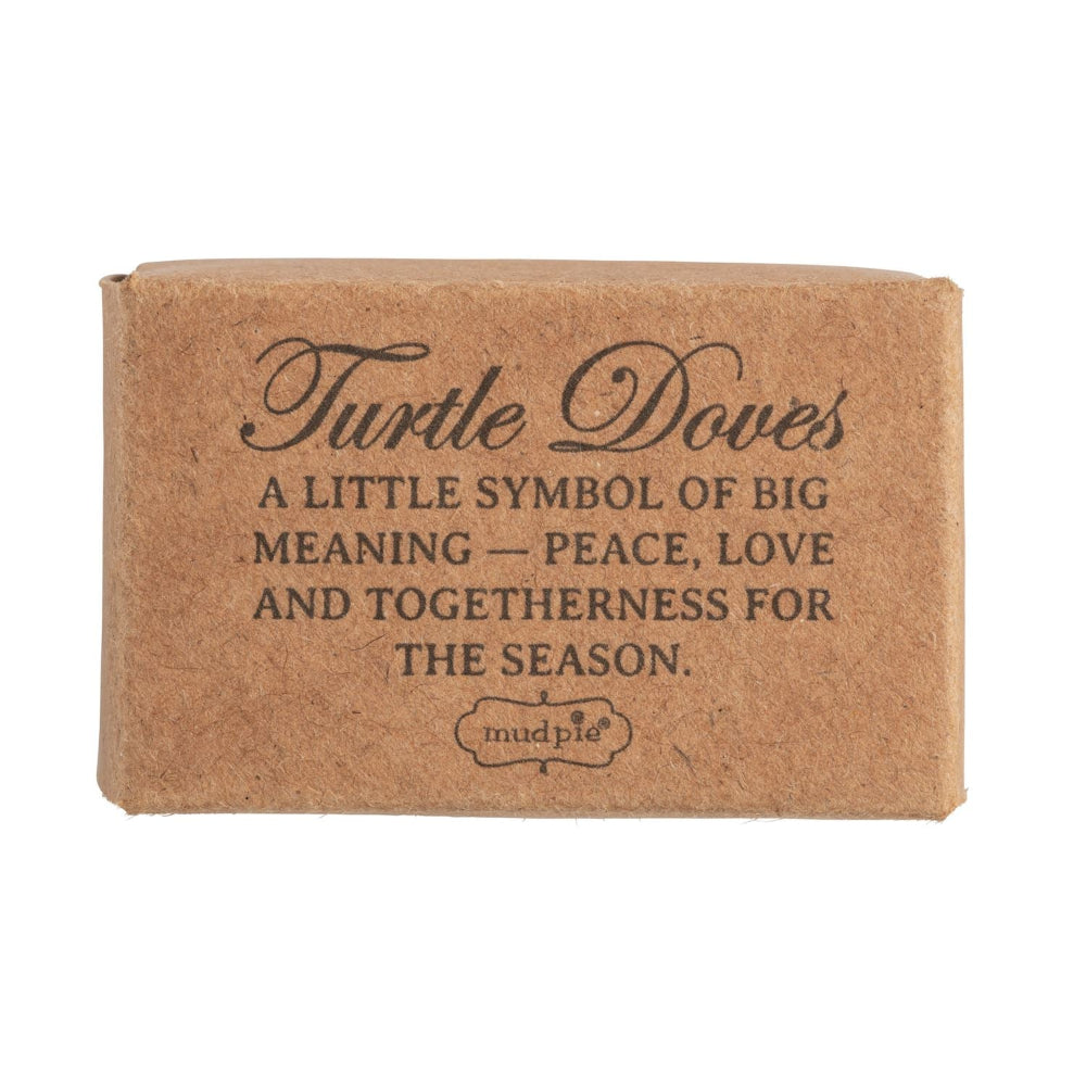 Small kraft box labeled "Turtle Doves" with sentimental printed text about holiday peace and love.