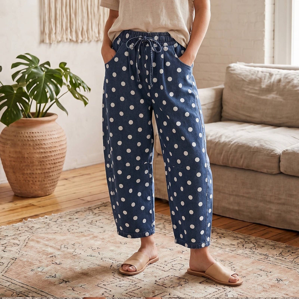 Blue denim barrel pants featuring white polka dots, a drawstring waist, and side pockets.
