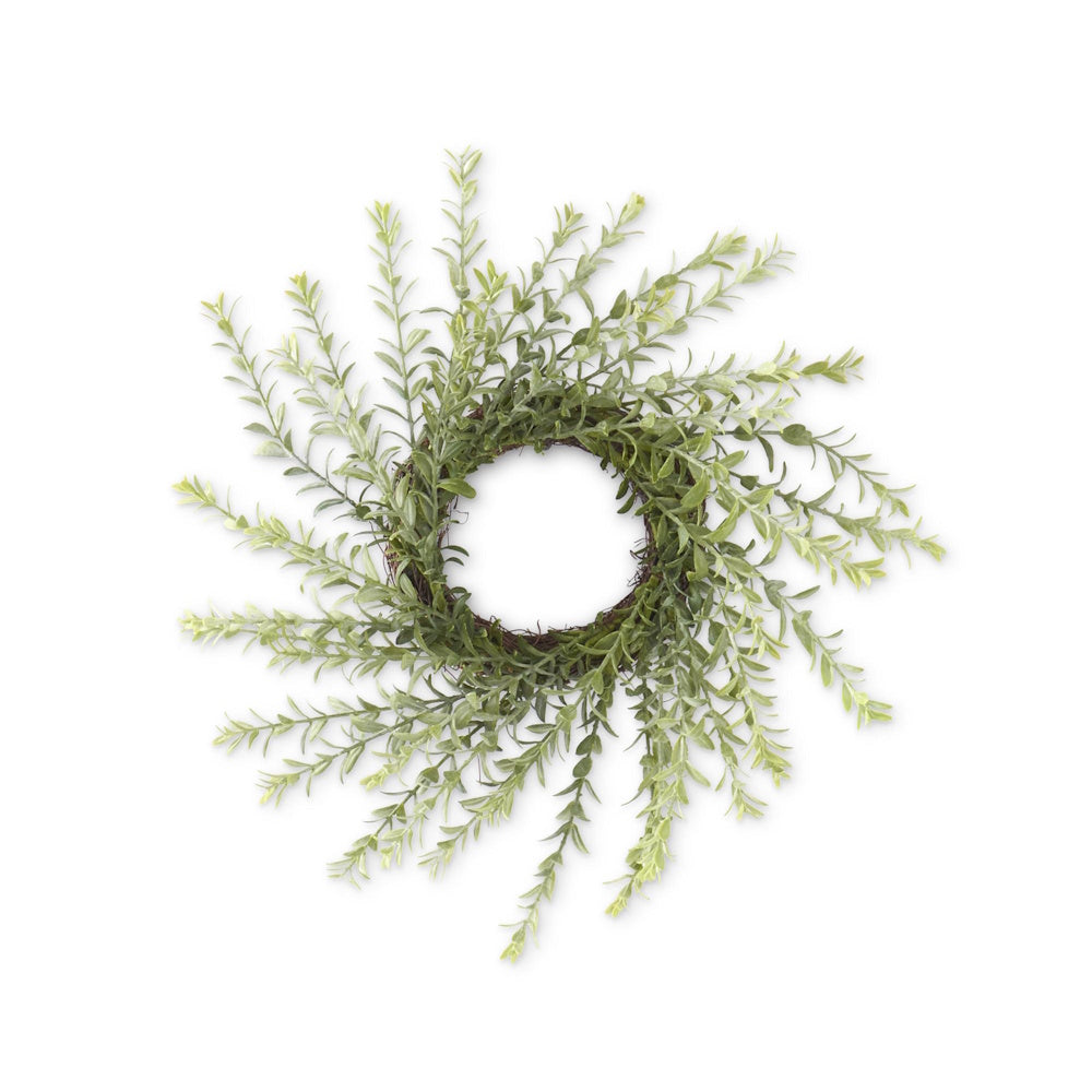 A small, circular candle ring made of powdered green myrtle foliage on a white background.