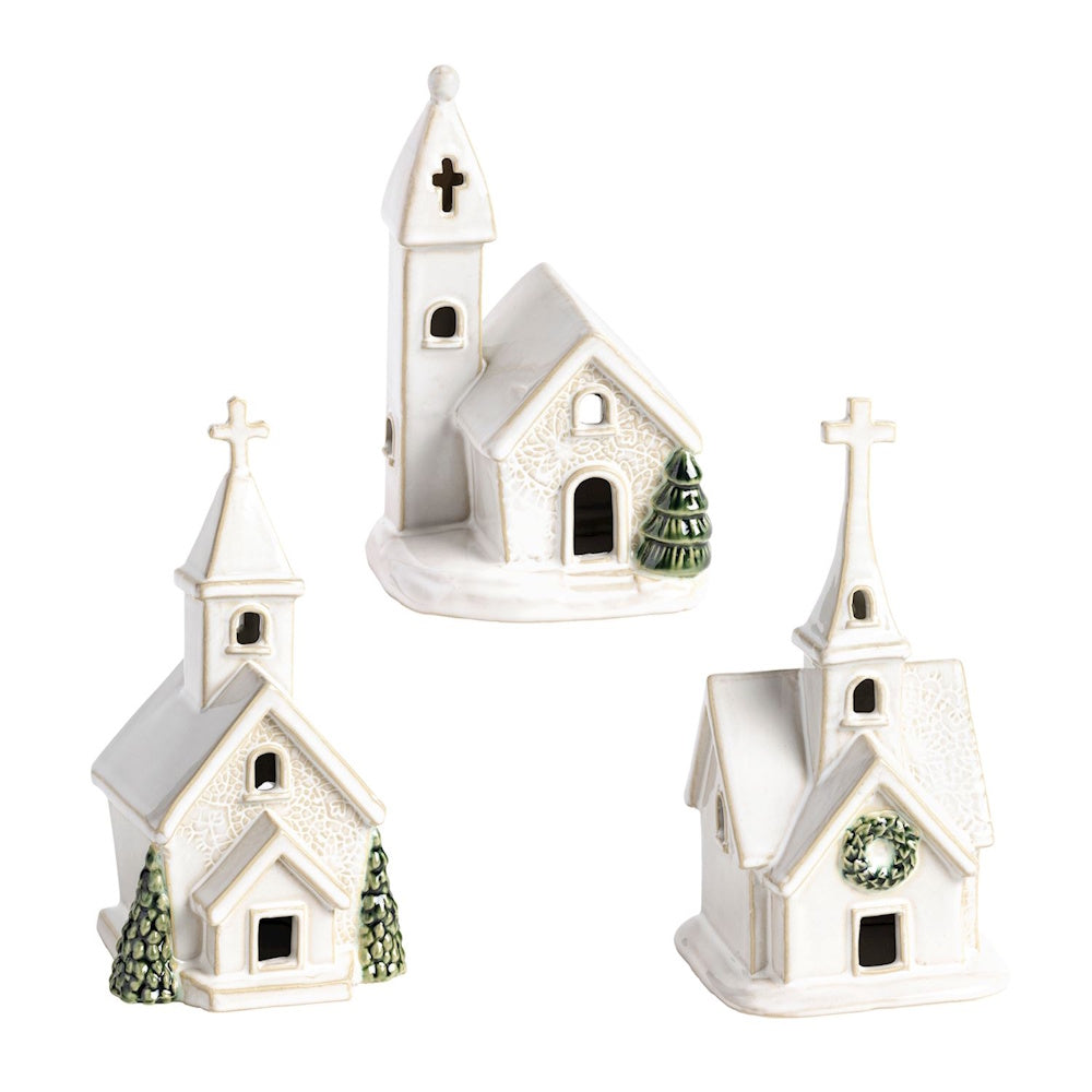 Set of three white ceramic miniature churches with lace texture details and green pine tree accents.
