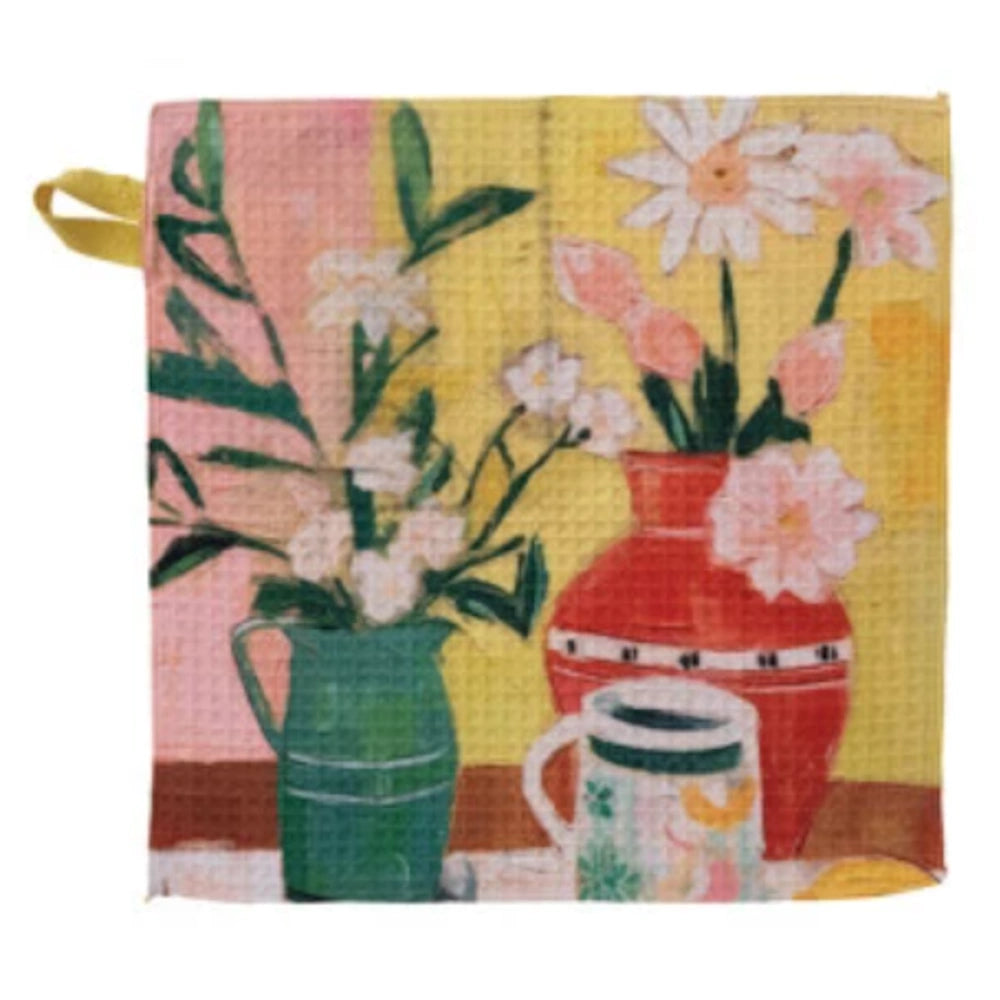 Vibrant waffle-weave dish cloth featuring a colorful painting of flowers in green and red vases with a patterned mug.