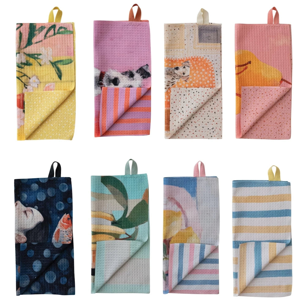 Assorted colorful, double-sided waffle-knit microfiber dish cloths with artistic prints of fruit, dogs, and patterns.