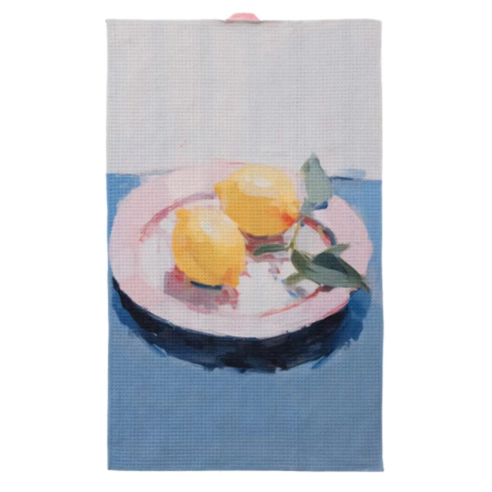 Sustainable recycled microfibre tea towel featuring a painted still life of two lemons on a pink plate against a blue base.
