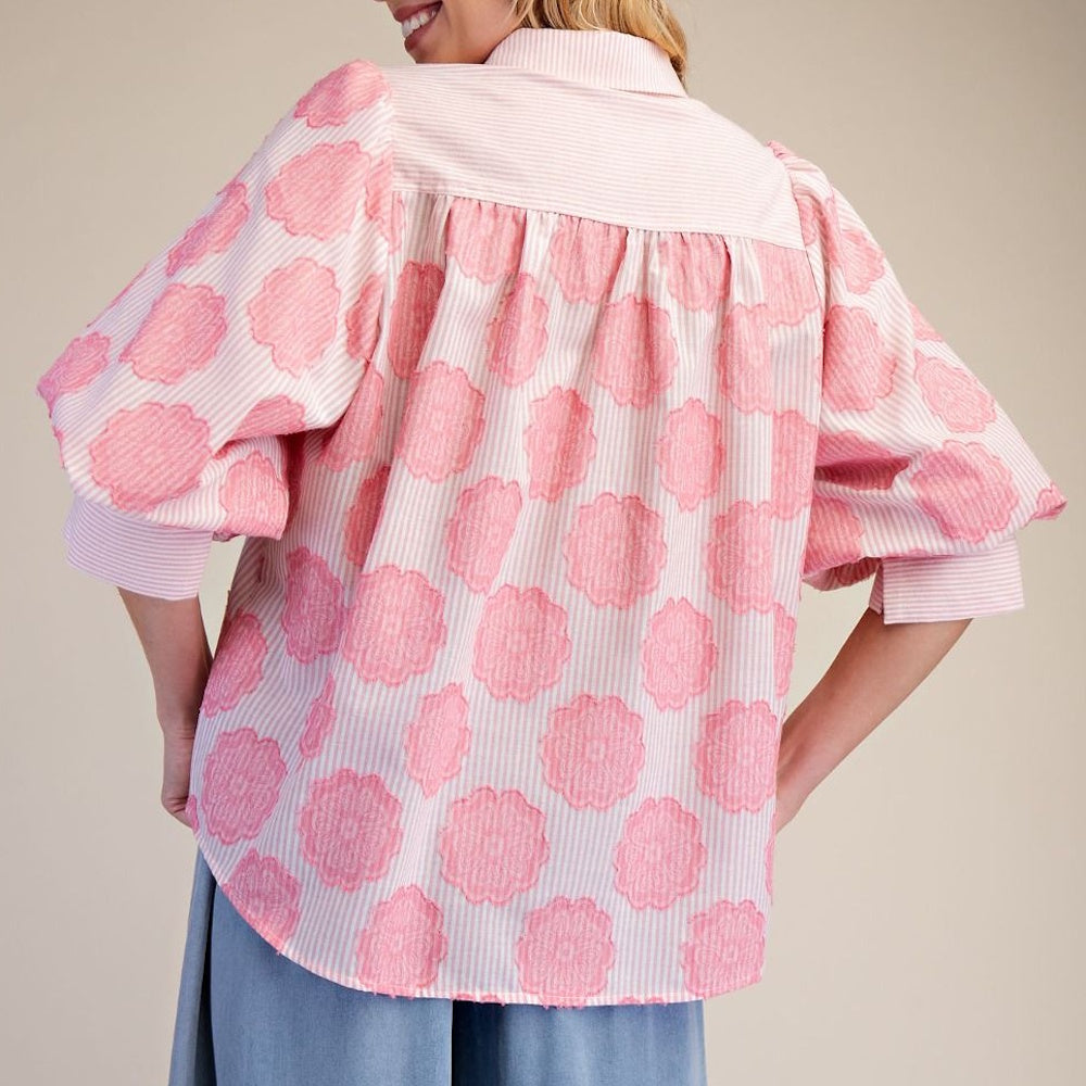 Pink and white striped button-down shirt featuring puff sleeves and large textured pink floral patterns.