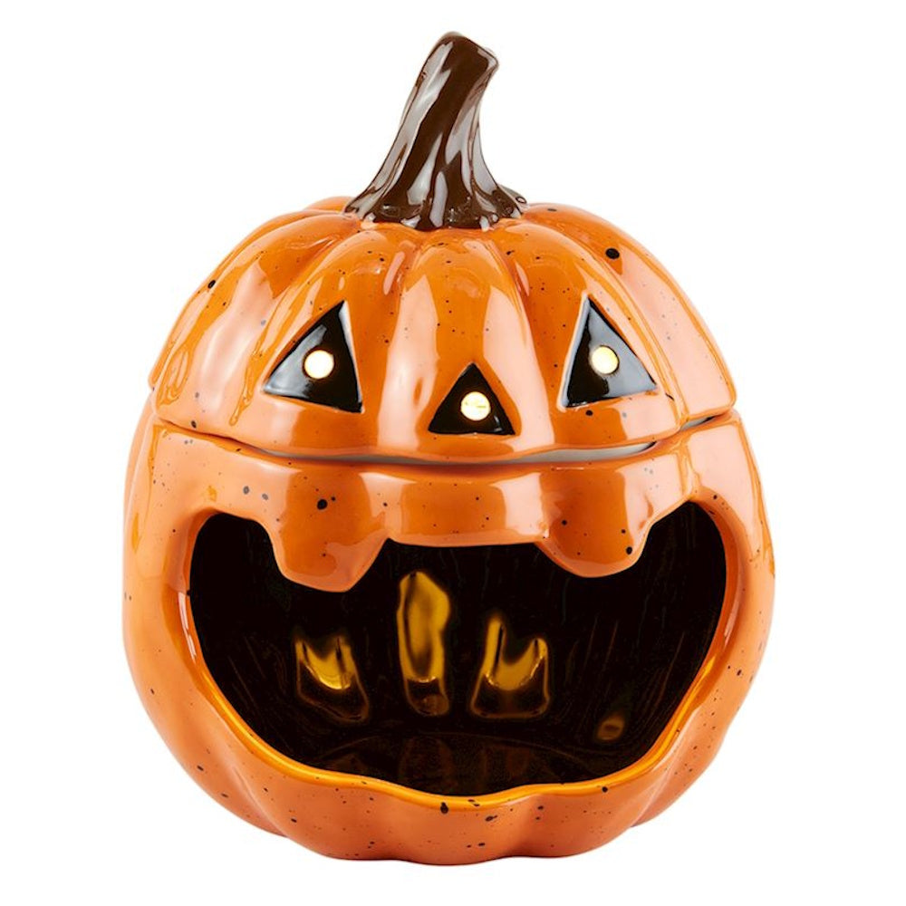 Ceramic Halloween jack-o'-lantern candy jar with an open mouth and glowing eyes.