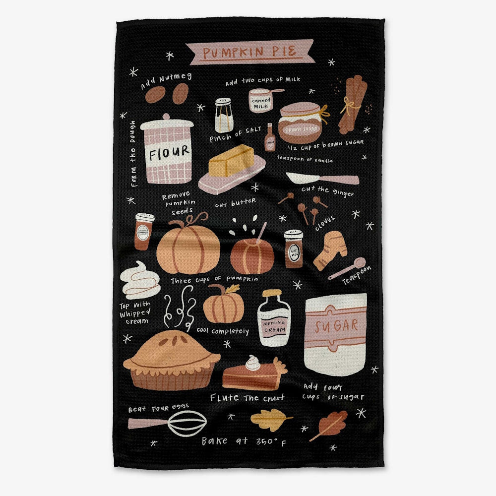 A black tea towel illustrated with a pumpkin pie recipe, including hand-drawn ingredients and steps.