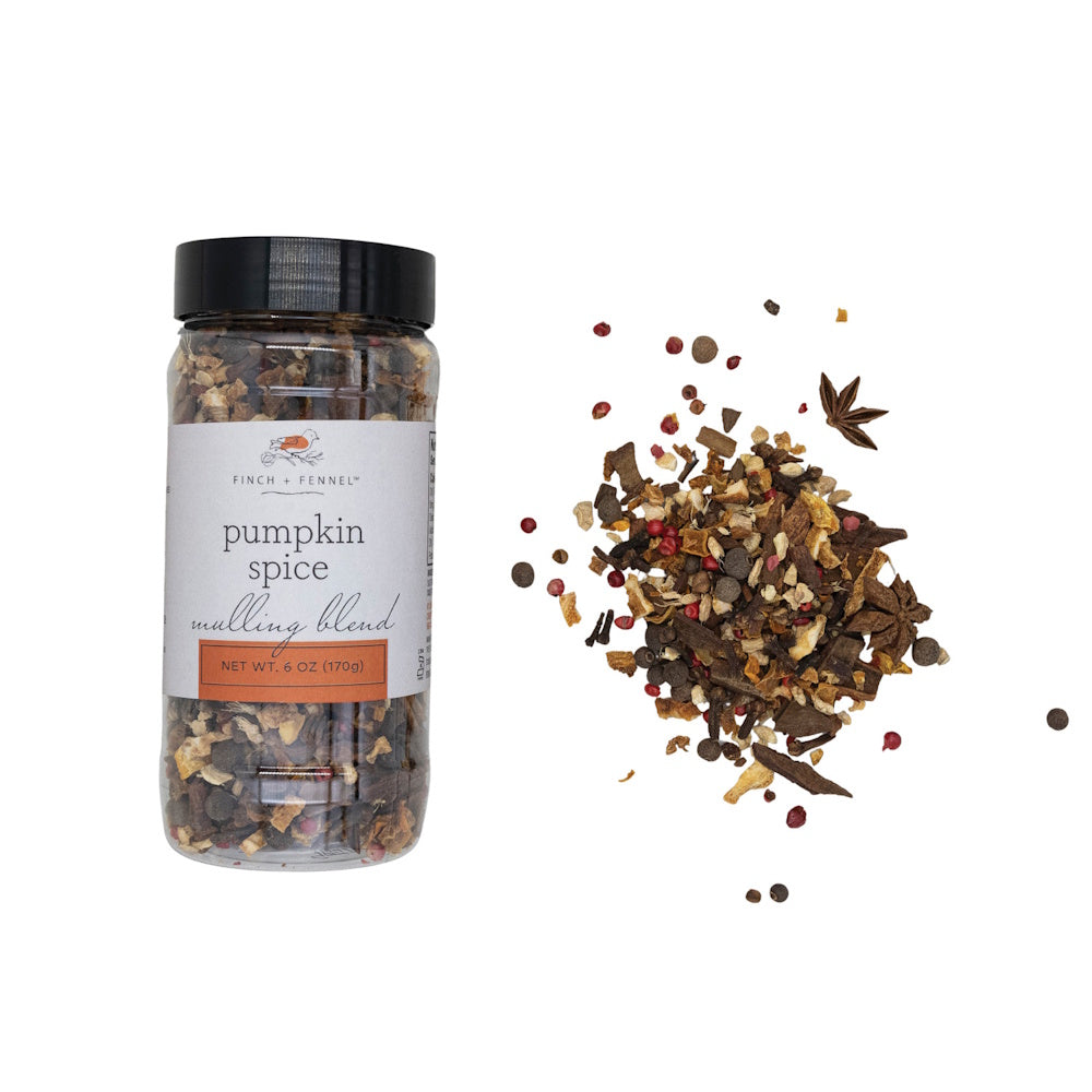 Jar of pumpkin spice mulling blend displayed next to a pile of loose spices.