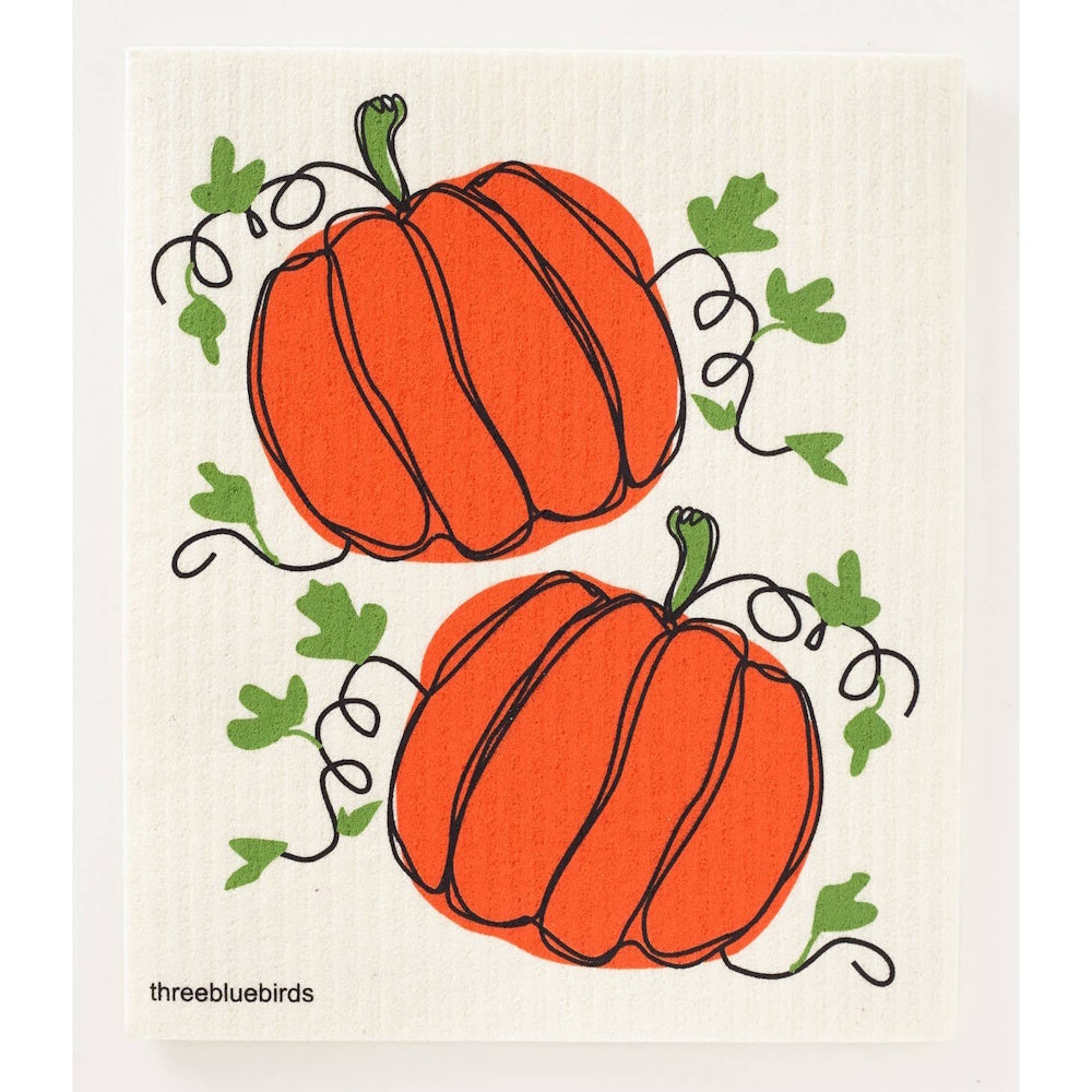 A Swedish dishcloth featuring a minimalist line art illustration of two orange pumpkins with green vines.