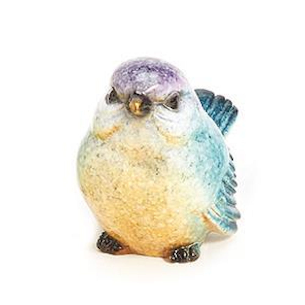 Small round ceramic bird figurine painted with purple, blue, and yellow speckled details on a white background.