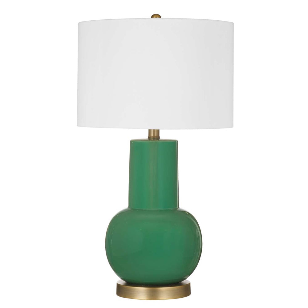 Modern table lamp featuring a glossy emerald green ceramic base, brass accents, and a white drum shade.