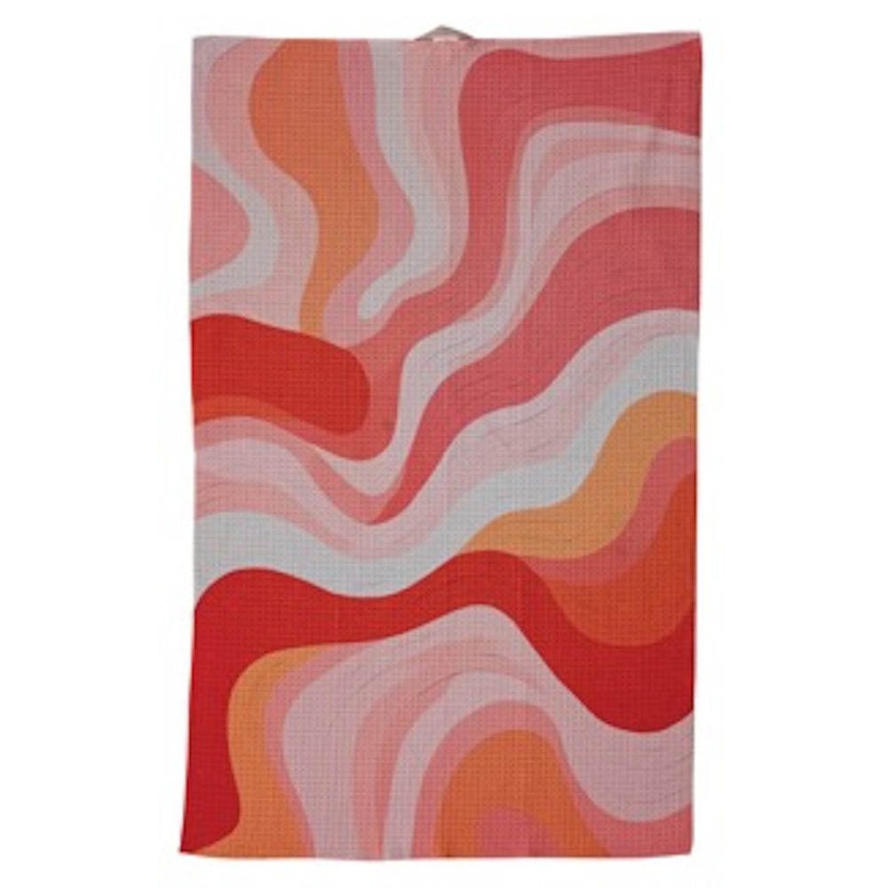 A rectangular tea towel with a retro, wavy pattern in shades of red, orange, pink, and white.