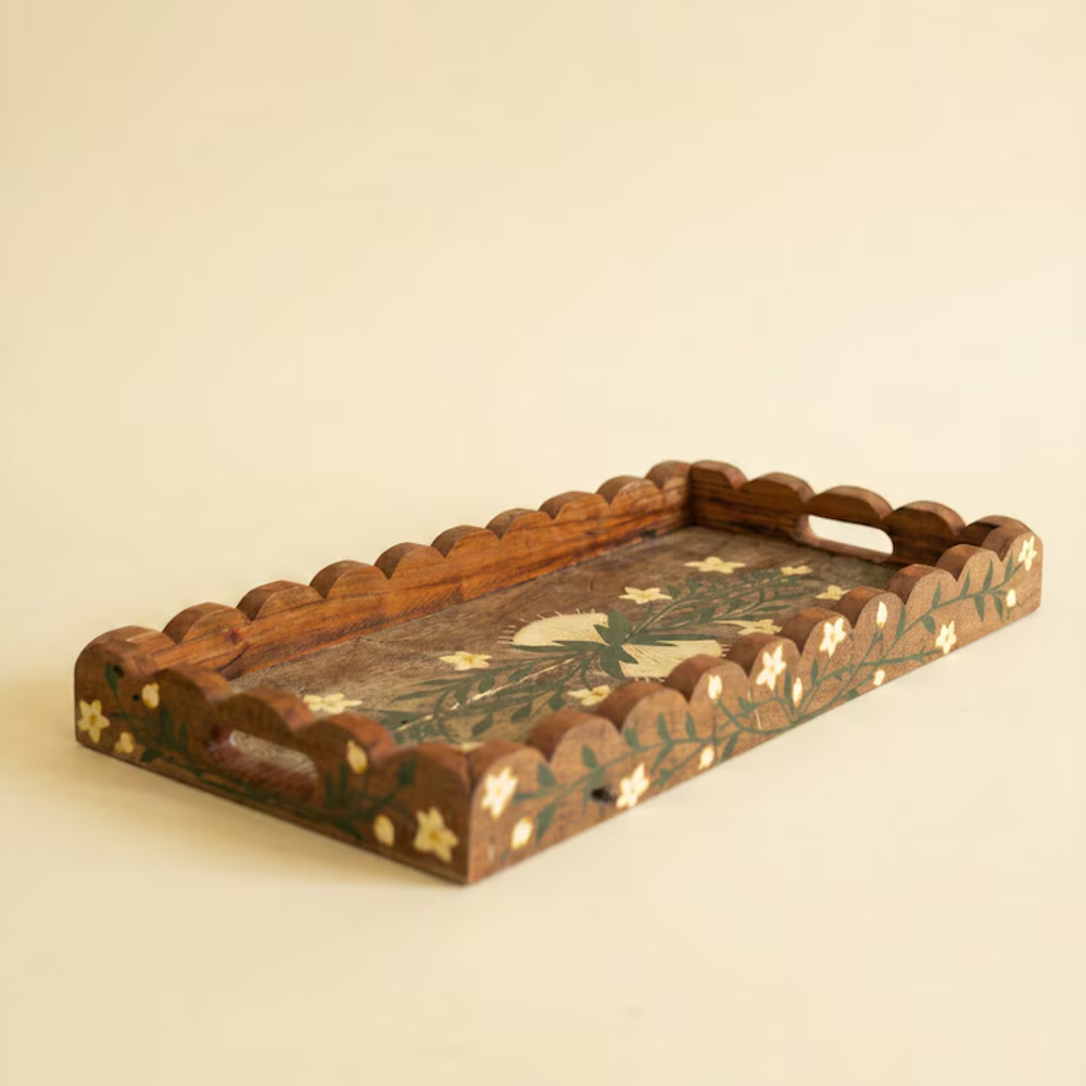 Rectangular wooden tray with scalloped edges and hand-painted floral motifs on a neutral background.