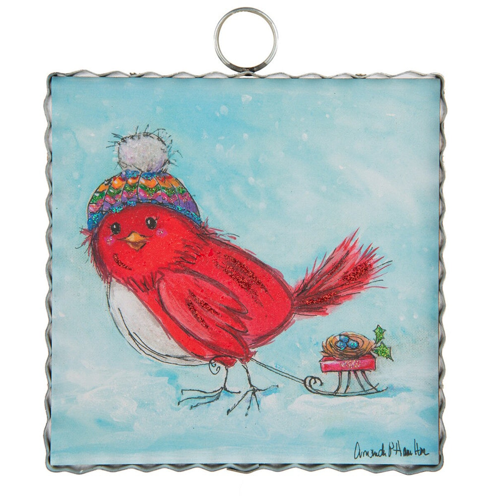 Front view of a square red bird metal art piece hanging on a wooden stand decorated with a red plaid ribbon.