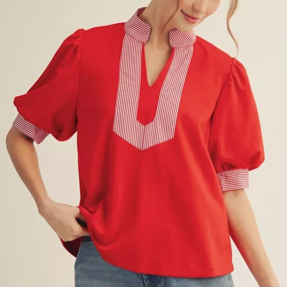 Red blouse with puff sleeves and white-and-red striped trim on the collar, neckline, and cuffs.
