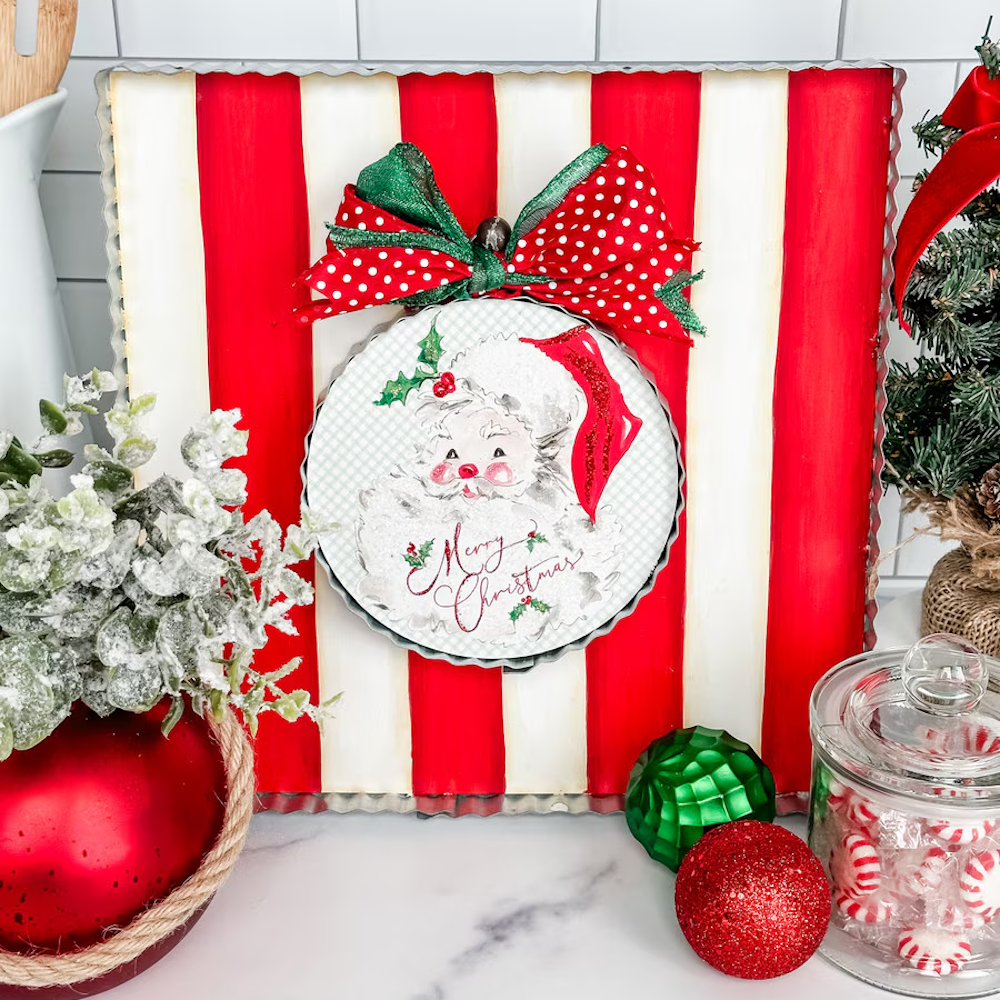 Front view of the red and white display board styled with a Merry Christmas Santa round and holiday decor.