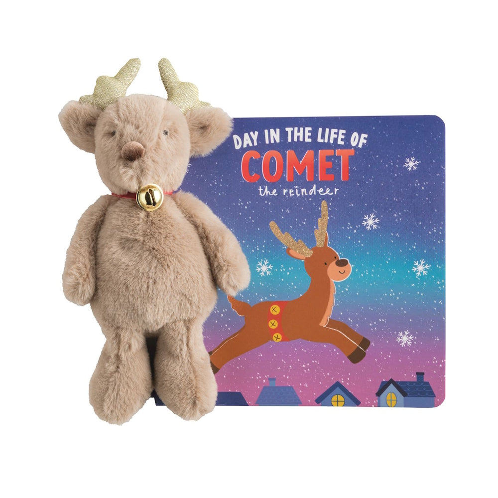 Plush reindeer toy standing next to a children's book titled "Day in the Life of Comet."