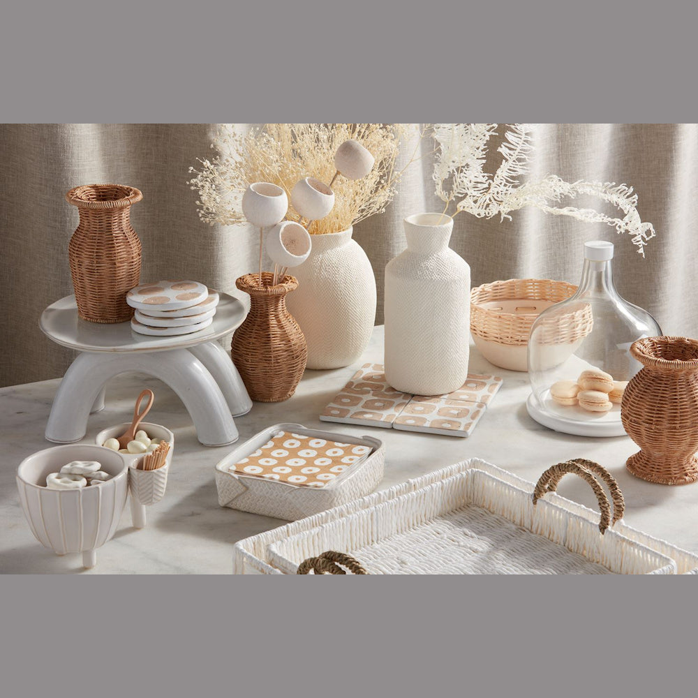 Boho table decor set with resin wicker vases, white ceramic trays, and neutral coasters on a marble surface.